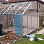 The first pane of polycarbonate is fitted to the greenhouse